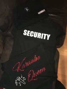 some t - shirts that say security and wanna be queen are laying on top of each other