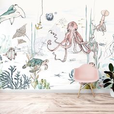 an ocean themed wallpaper mural in a living room with pink chair and white walls