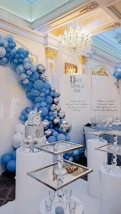 a room filled with lots of white and blue balloons