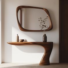 a wooden table with a mirror and vase on it