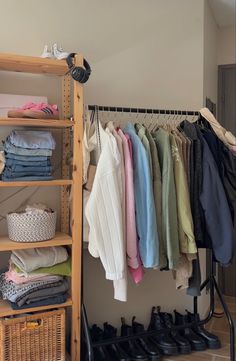 an organized closet with clothes and shoes hanging on the rack, next to a shoe rack