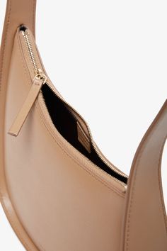 Beige smooth calfskin leather shoulder bag from The Row. The Half Moon bag has a beautiful silhouette, a flat shoulder strap that is perfectly curved and a zipped top. Suede lining inside.Measurements: L30 x H13 x W9 cmMade in Italy Evening Beige Leather Baguette Bag, Beige Leather Baguette Bag For Evening, Evening Beige Soft Leather Baguette Bag, Modern Beige Leather Baguette Bag, Chic Beige Hobo Bag For Business, Beige Leather Baguette Bag With Zipper Closure, Classic Beige Hobo Bag With Smooth Grain, Beige Shoulder Bag With Zipper Closure For Evening, Modern Beige Soft Leather Baguette Bag