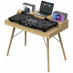 a laptop computer sitting on top of a wooden table next to a dj's turntable