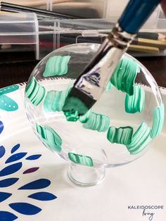 a close up of a glass bowl with a brush in it