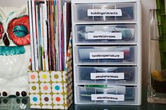 the drawers are organized with labels and plastic bins for organizing books, magazines, and more