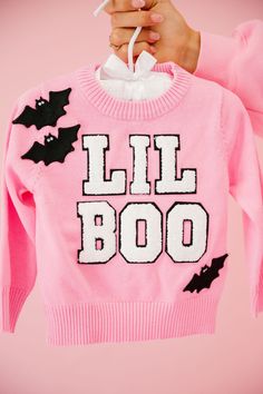 Dress your little one in style with our MINI KIDS LIL BOO PINK SWEATER. This pink knit sweater features a playful touch with small white varsity "Lil Boo" letters and black bat patches. Perfect for a cute and quirky look! All orders are currently shipping within 14 business days. To receive item quicker, expedited shipping is available at checkout. **ALL HALLOWEEN ORDERS MUST BE PLACED WITH EXPEDITED SHIPPING TO GUARANTEE DELIVERY BY OCT. 31 IF PLACED AFTER OCT. 15** Silver Sequin Skirt, Pink Trucker Hat, Pink Knit Sweater, Pink Pullover, Pink Knit, Black Bat, Pink Kids, Oct 31, Kids Sweater