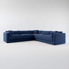 a blue sectional sofa with pillows on the top and bottom part, in front of a white background