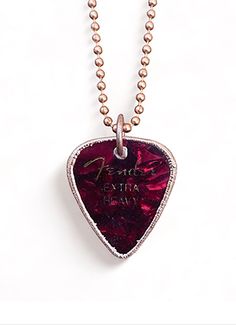 a necklace with a red guitar pick on it