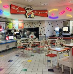 the inside of a fast food restaurant with tables and chairs