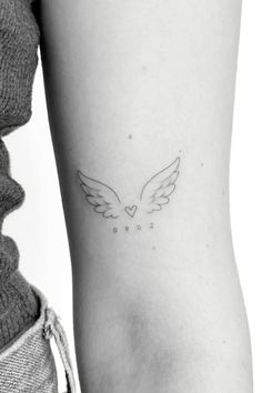 a woman's arm with a small tattoo on the left side of her body