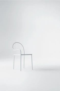 a white chair sitting on top of a white floor