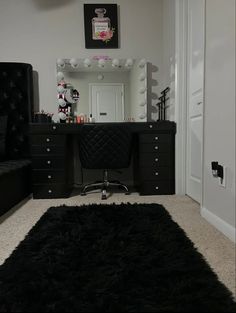 a bedroom with a black vanity and mirror