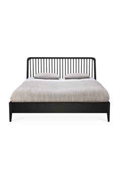 a black bed frame with two pillows on it