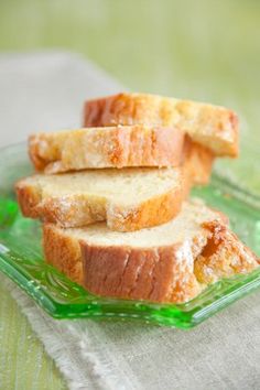 three slices of bread sitting on top of a green glass plate next to a napkin