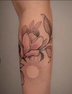 a woman's leg with a flower tattoo on the side of her arm and an apple in the middle