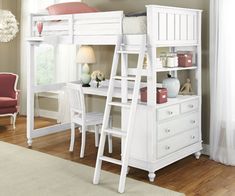 a white bunk bed sitting next to a desk with a ladder in front of it