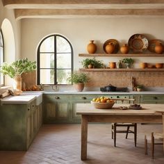 a kitchen filled with lots of counter top space next to a wooden dining room table