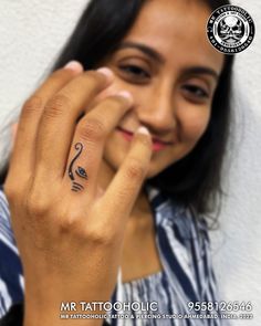 a woman with a tattoo on her left hand