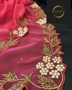 a close up of a red cloth with gold trimmings and flowers on it