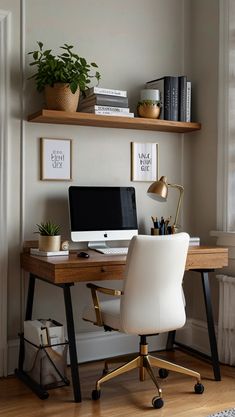 a desk with a computer on top of it and some plants in front of it