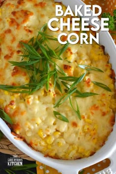 baked cheesy corn casserole in a white dish with green garnish