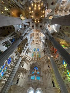 the inside of a building with many windows and lights on each side of the ceiling