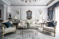 a living room filled with furniture and a chandelier