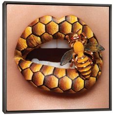 a woman's lip with a bee on it and honeycombs painted on the lip