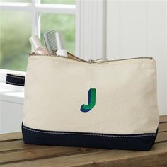 * Embroidered with any name , initial, or monogram * Choose from multiple thread colors and font options * Thread colors shown are emerald green and navy blue  * Quality crafted of 12 oz. medium-weight natural canvas with a silver zipper pull. * Colored trim lines the bottom of the bag keeping it neutral to coordinate with any outfit or occasion. * Measures 11L x 3W x 7H * Hand wash cold. Lay flat to dry * Imported Whether you are looking for a travel accessory or an everyday makeup bag, call it Colored Trim, Name Canvas, Canvas Makeup Bag, Personalized Canvas, Thread Colors, Personalised Canvas, Silver Zipper, Everyday Makeup, Travel Accessories