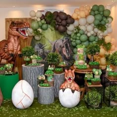 a dinosaur themed birthday party with balloons and decorations