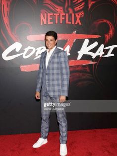 a man in a suit standing on a red carpet at the netflix tv series's cobra