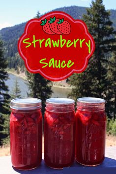 three jars filled with red liquid sitting on top of a table