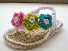 crocheted sandals with flowers and buttons on them