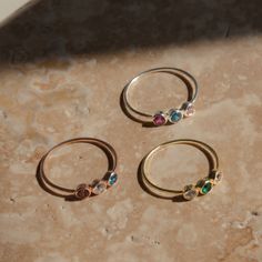 Three vibrant birthstones sparkle in the center row of a delicate polished band on our Triple Birthstone Ring. This unique take on the typical multiple stone ring can be fully customizable with the birthstones of your nearest and dearest! Material: High-Quality Solid 925 Sterling Silver Finish: Sterling Silver ∙ 18K Gold ∙ Rose Gold Stone Dimensions: 3mm SKU: HH-RH07 Sizing Guide Rings are created true to standard US sizing. For the best fit we suggest having your finger(s) sized. We offer a phy Mom Ring, Gold Stone, Rings Simple, Types Of Rings, Birthstone Ring, Silver Roses, Silver Rose Gold, Stone Ring, Solid 925 Sterling Silver