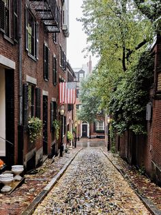 a cobblestone street lined with brick buildings