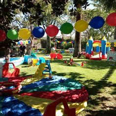 an outdoor party with colorful decorations and balloons