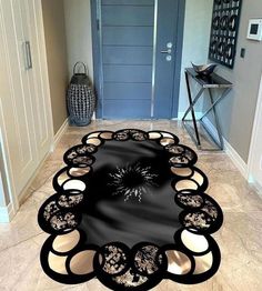 a black and white area rug in the middle of a hallway