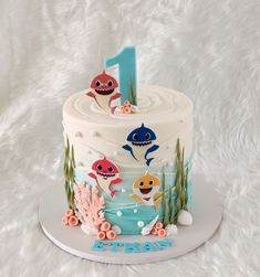 a birthday cake decorated with an ocean theme and under the sea animals is one year old