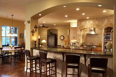 a large kitchen with an island in the middle and lots of counter space on each side