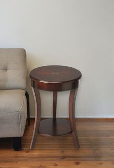 a living room with a chair and a small table in front of the couches