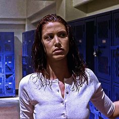 a woman standing in front of some lockers