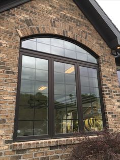 the side of a brick building with large windows