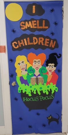 a door decorated with children's pictures and writing on the front door, which reads i smell children hocsies pocuss