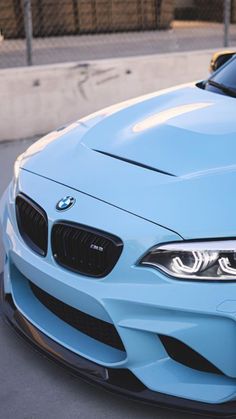 a blue bmw car parked on the street