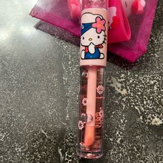 a pink hello kitty pen sitting on top of a counter