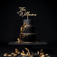 a black and gold wedding cake with the words the williams on top, surrounded by leaves