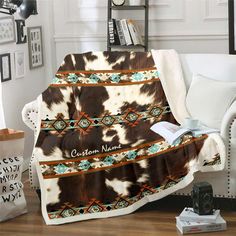 a cow print blanket sitting on top of a couch