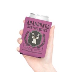 a hand holding a purple can cooler with an image of a deer on the front