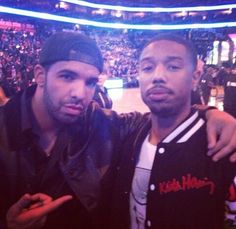 two men standing next to each other at a basketball game