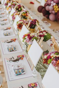 a long table with flowers and place cards on it